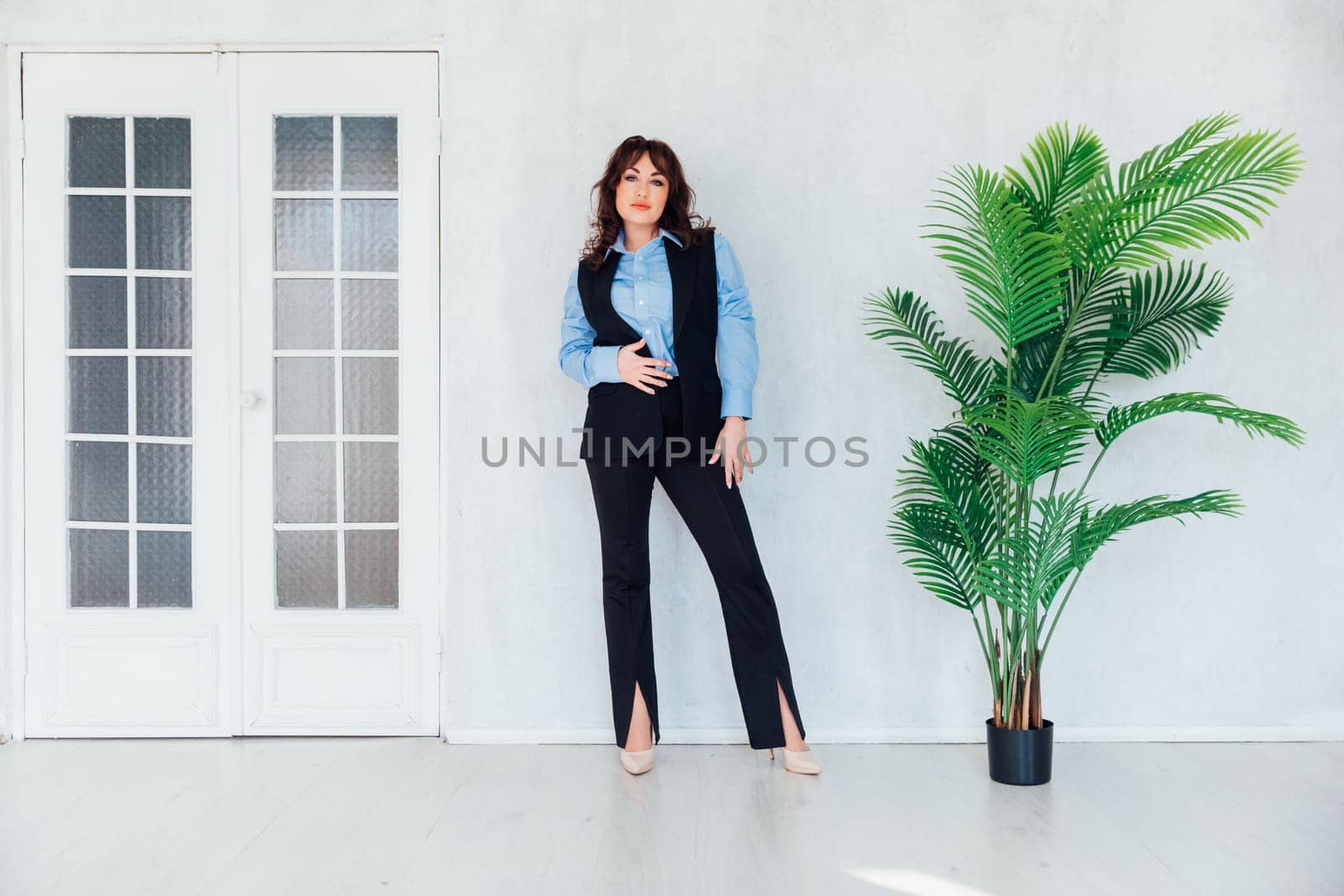 Portrait of a beautiful young woman in a business suit on a white office