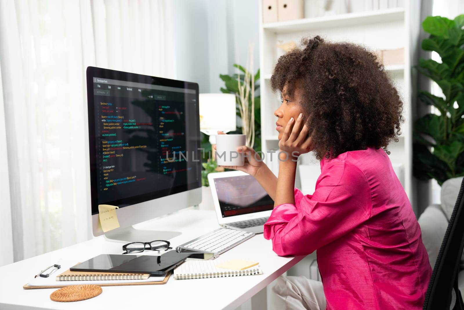 Young working African woman creating coding website developer, thinking data information designer at home office, focusing on laptop Concept of analytical data center in java project job. Tastemaker.