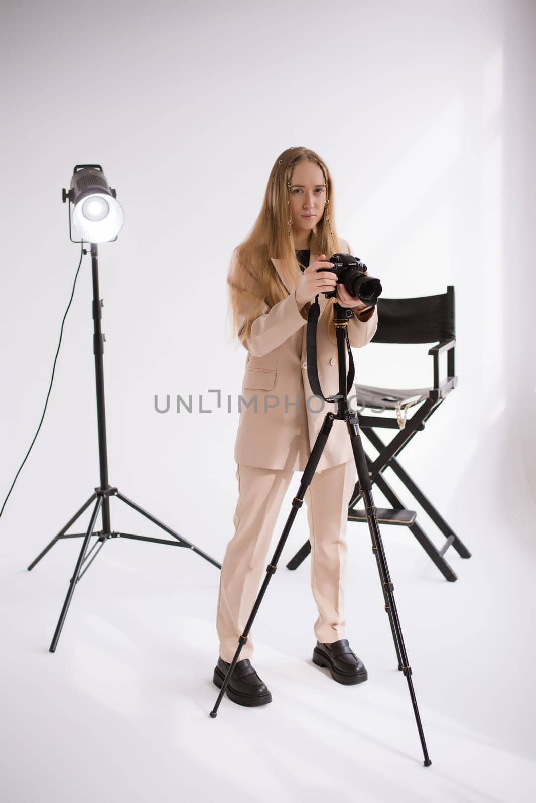 A woman videographer with camera in studio by OksanaFedorchuk