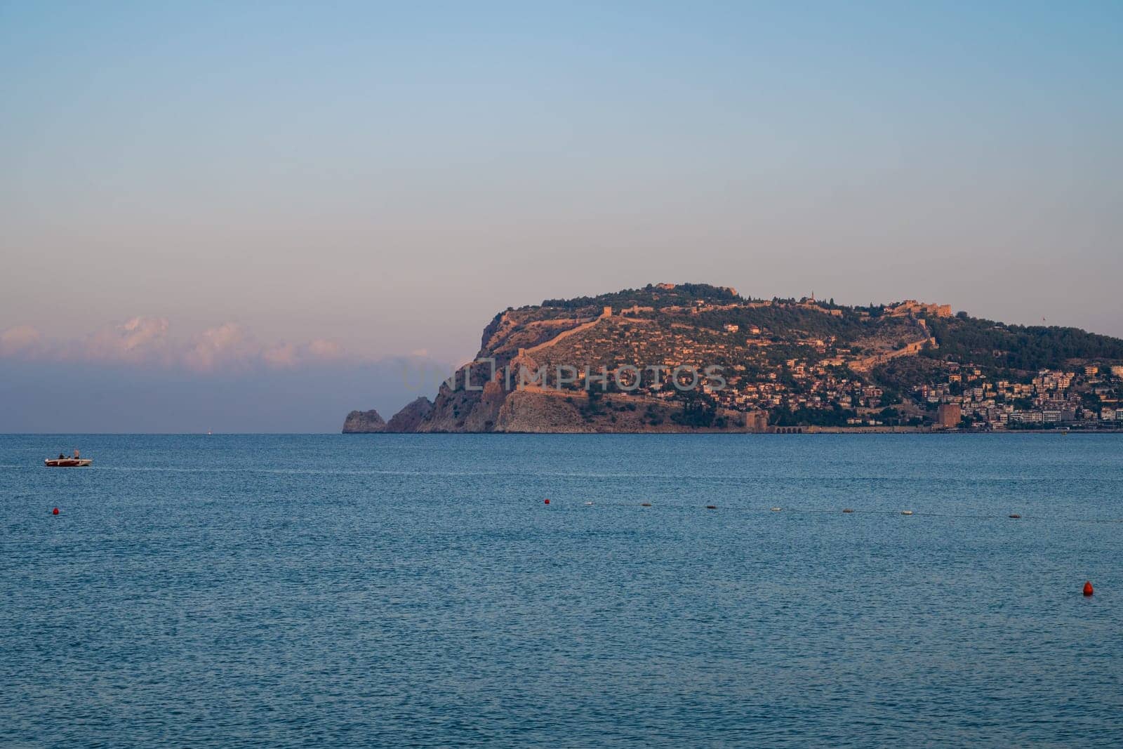 Beautiful sunrise scene on Alanya beach with view to famous Alanya island, in Turkey
