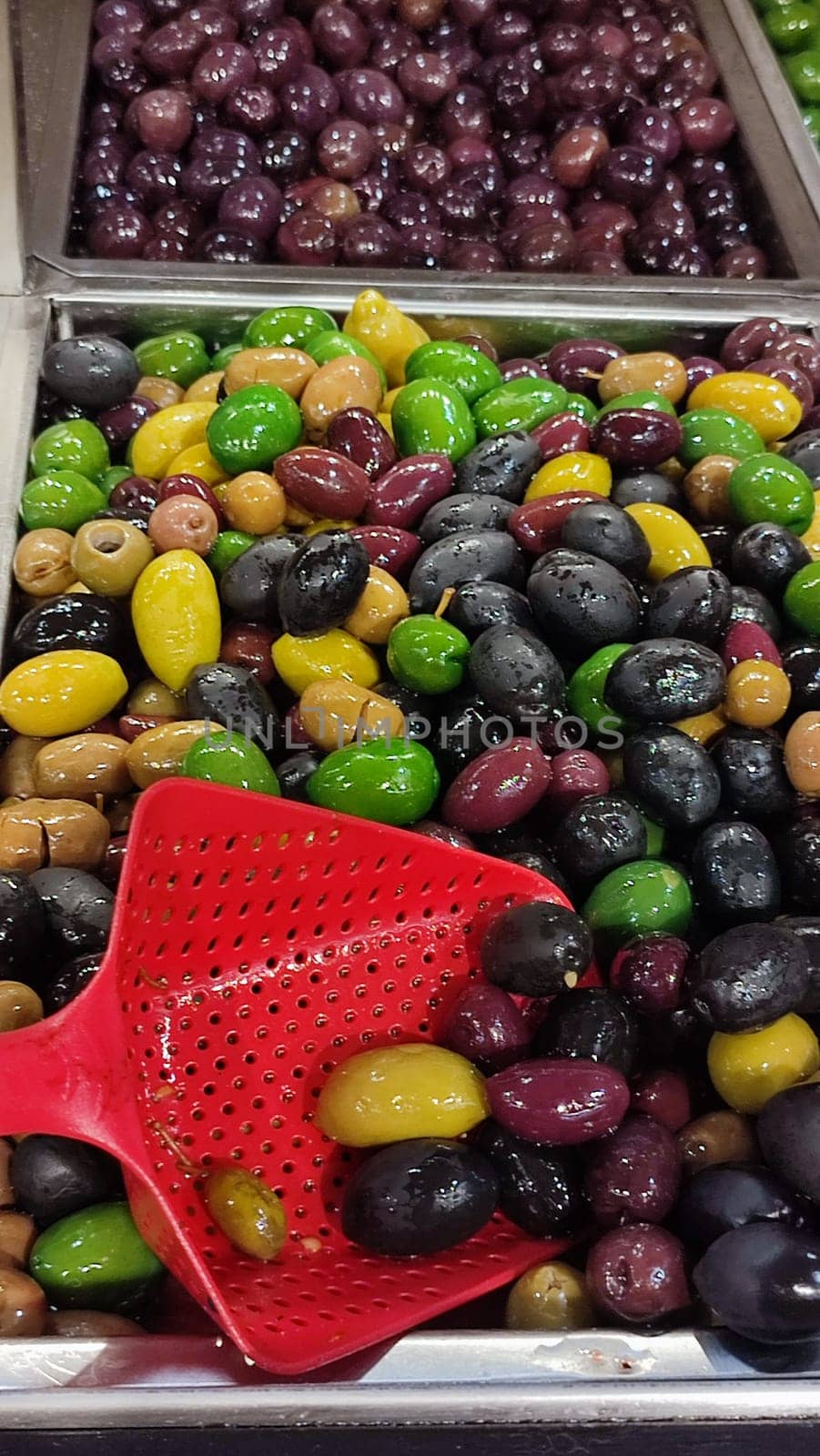 large pickled olives on sale products in the store. green olives on sale in the food store High quality photo