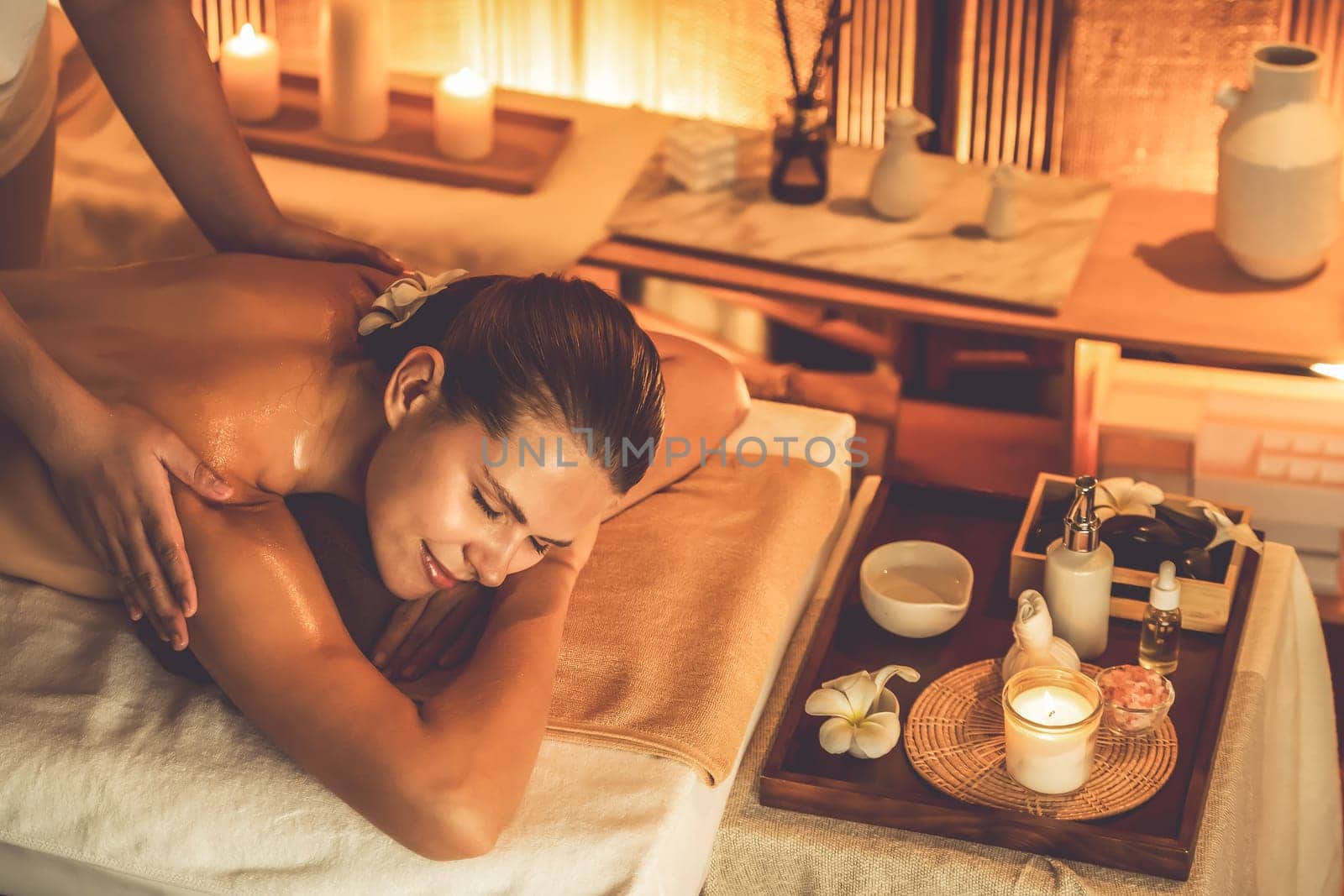 Caucasian woman customer enjoying relaxing anti-stress massage. Quiescent by biancoblue