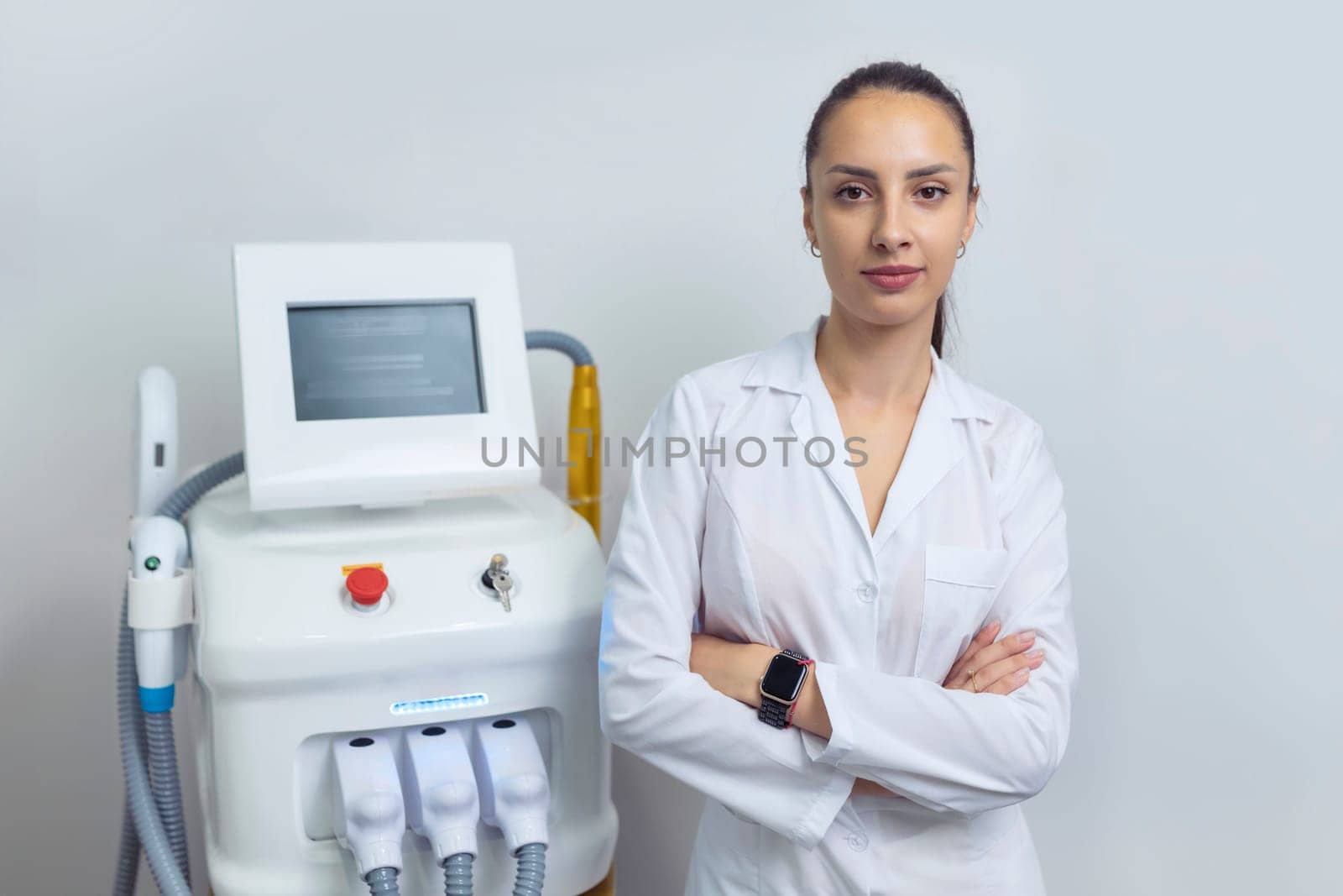 Doctor specialist beautician stands near the laser hair removal device.