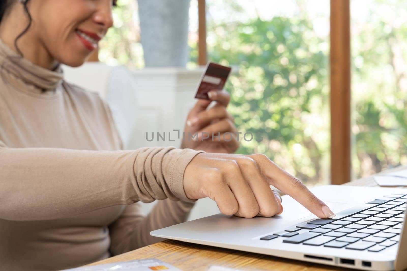 Close up credit card using for online payment, banking and shopping on the internet network with laptop computer showing credit card technology for online secured wallet top up and crucial purchase