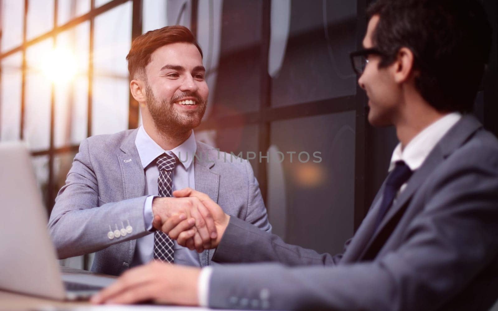 Teamwork, collaboration and thank you female employee shaking hands with colleague