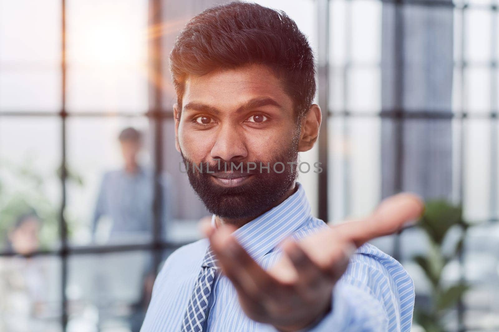 male investor beard looking at camera and smiling in modern office