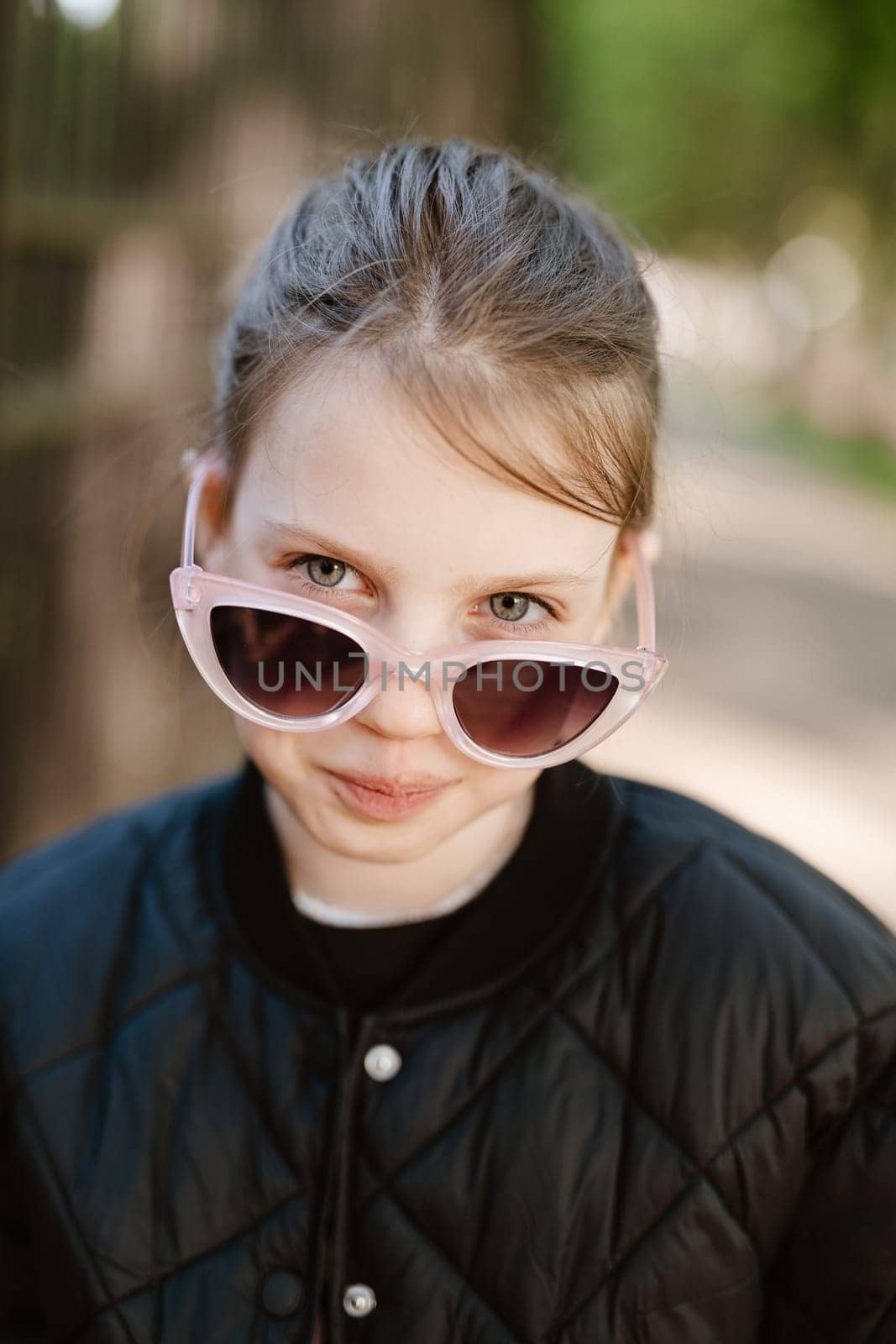 Funny girl playing outdoor surprised emotional child in sunglasses 11 years old girl, family vacations by sarymsakov