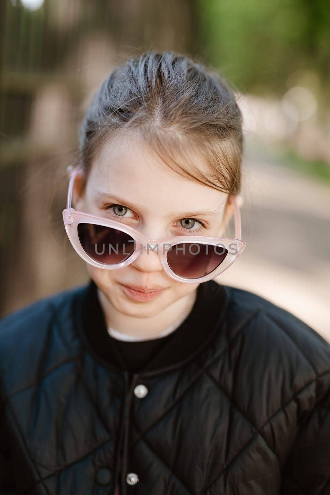 Funny girl playing outdoor surprised emotional child in sunglasses 11 years old girl, family vacations.