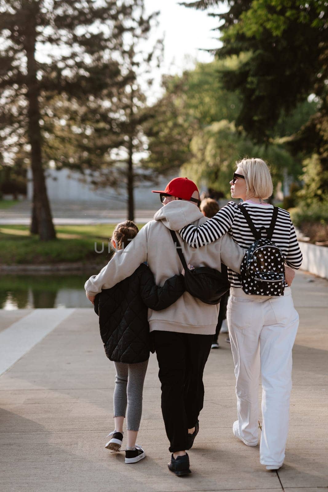 Family photo walking together in the park.