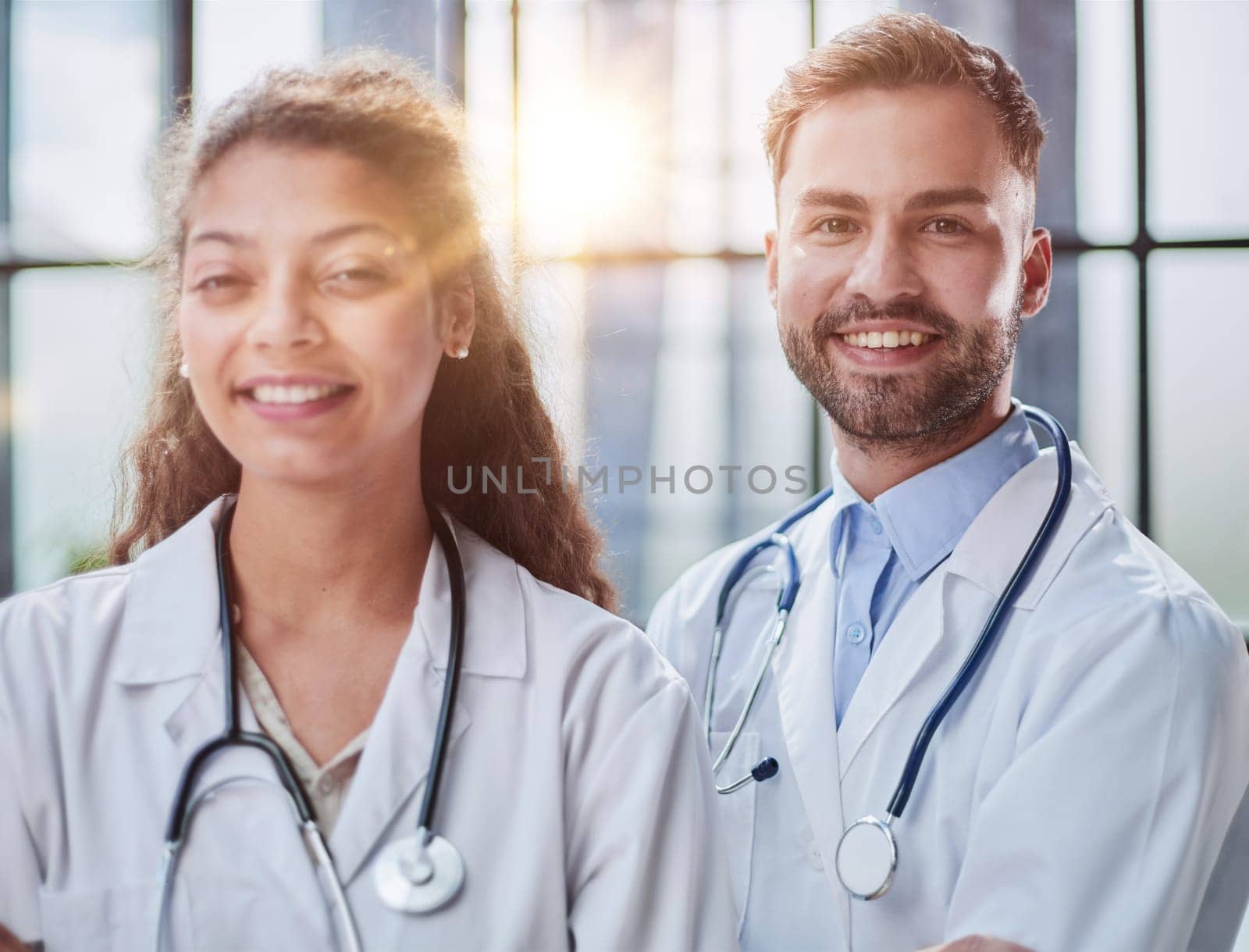 Young male and female dentists look into the distance in a hospital room