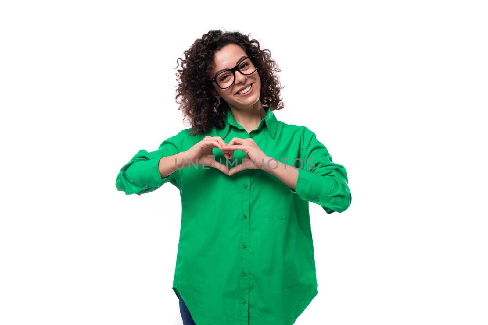 smiling office brunette woman with curly hair dressed in a green shirt on a white background by TRMK