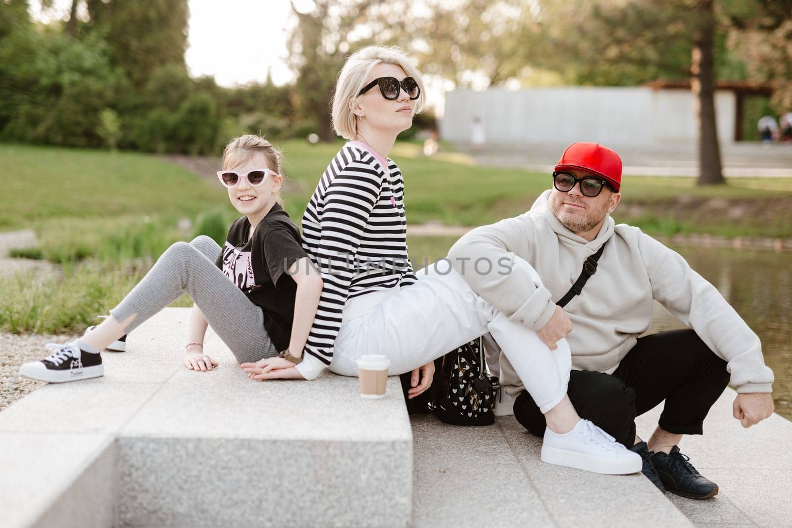 Young family with their daughter at park having fun together.