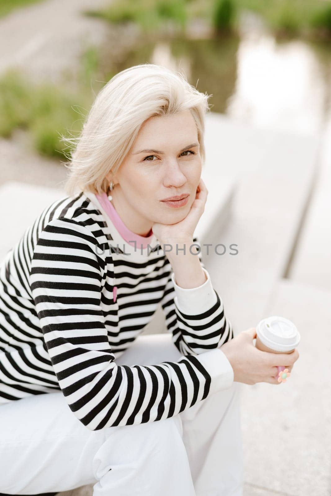 Young beautiful woman person are happy and enjoy with coffee drink in the morning at park, relax lifestyle by holding coffee or tea cup at nature outdoor park, smile pretty girl with freedom time