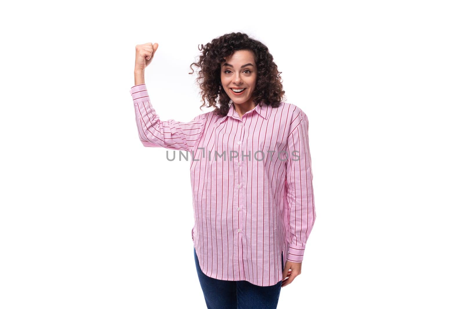young curly brunette model woman wearing a pink striped shirt.