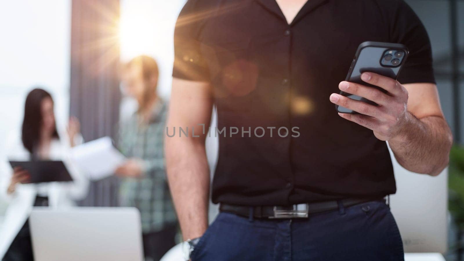 Close-up of a smartphone screen in the hands of a businessman. by Prosto
