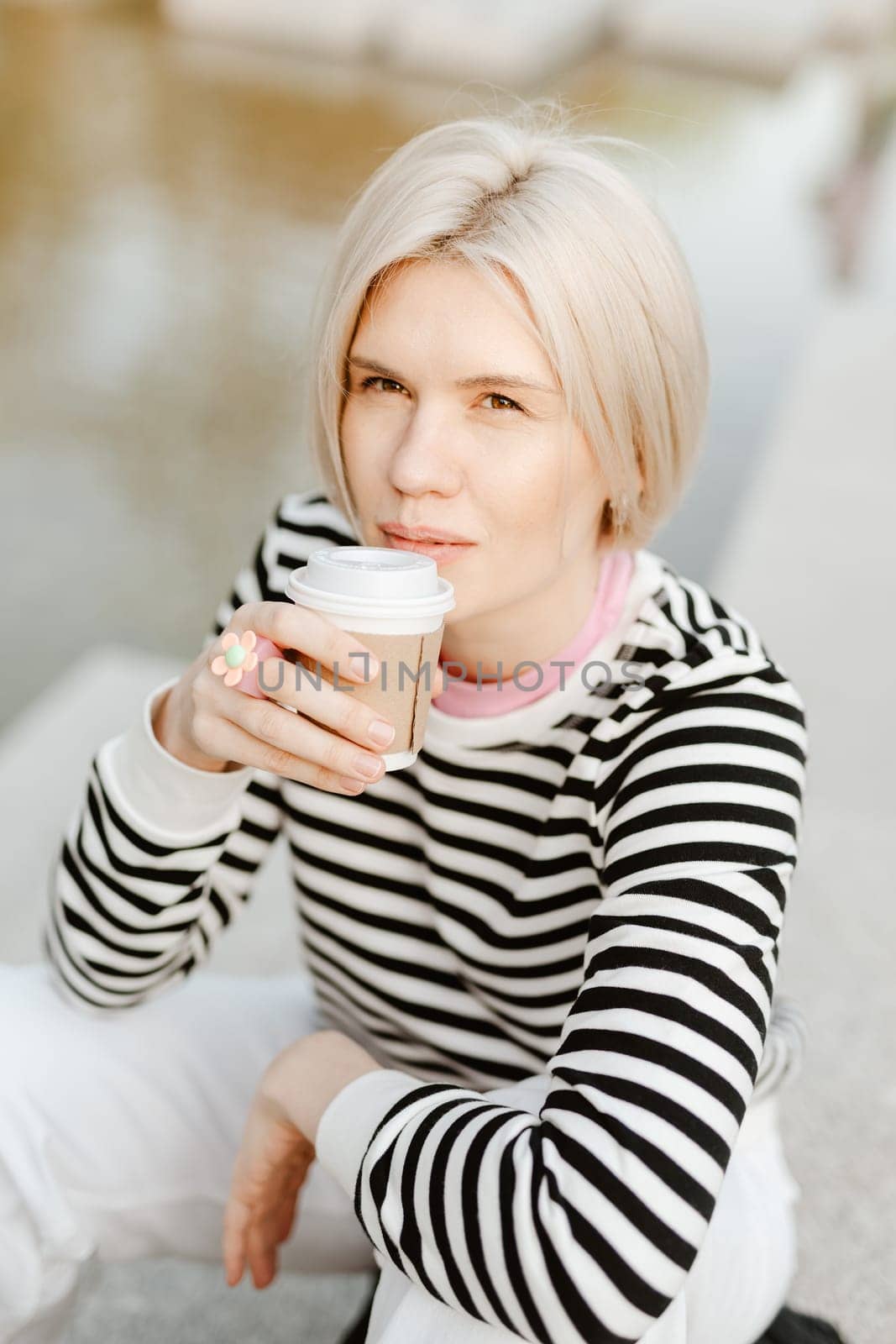 Young beautiful woman person are happy and enjoy with coffee drink in the morning at park, relax lifestyle by holding coffee or tea cup at nature outdoor park, smile pretty girl with freedom time