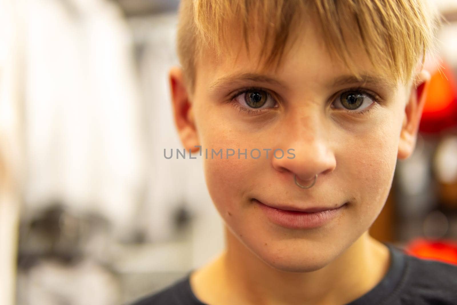 portrait of a smiling teenager with an earring in his nose. High quality photo