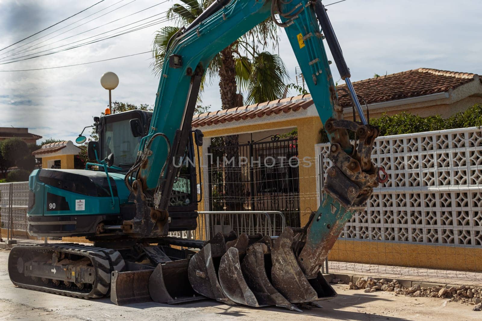 An excavator stands on the road on the street close-up and a place for an inscription. High quality photo