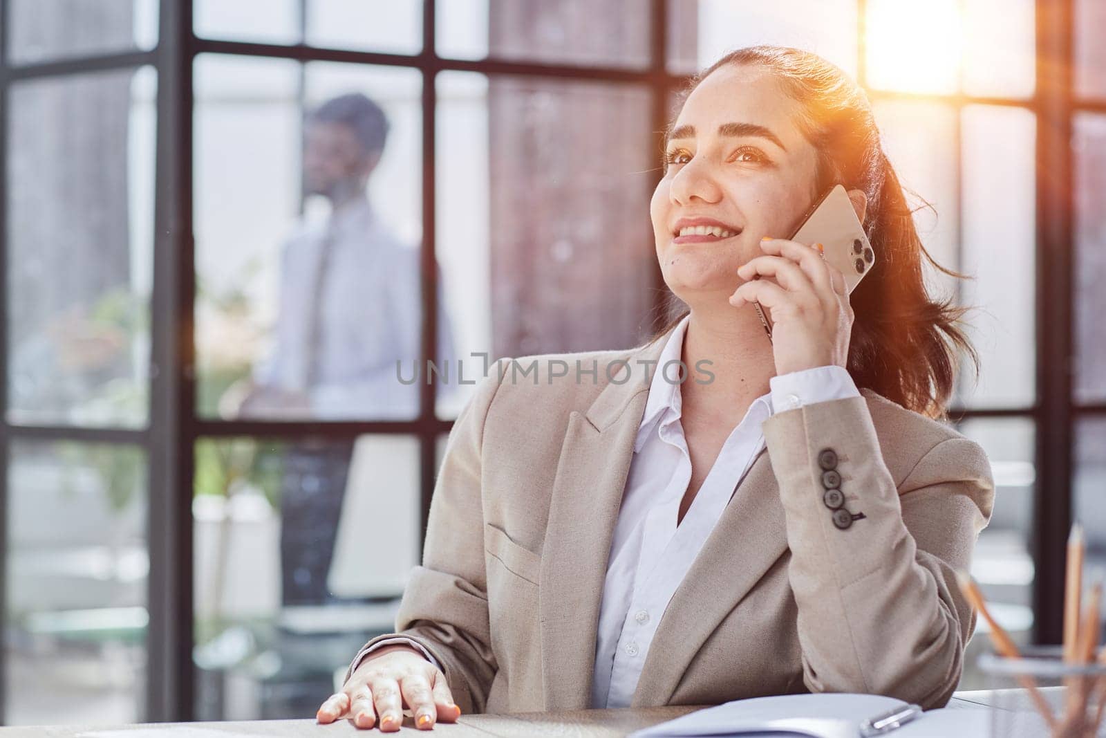 Portrait of smiling female who is talking by phone by Prosto