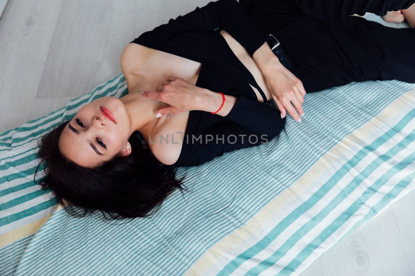 woman lying on sleeping mattress on the floor