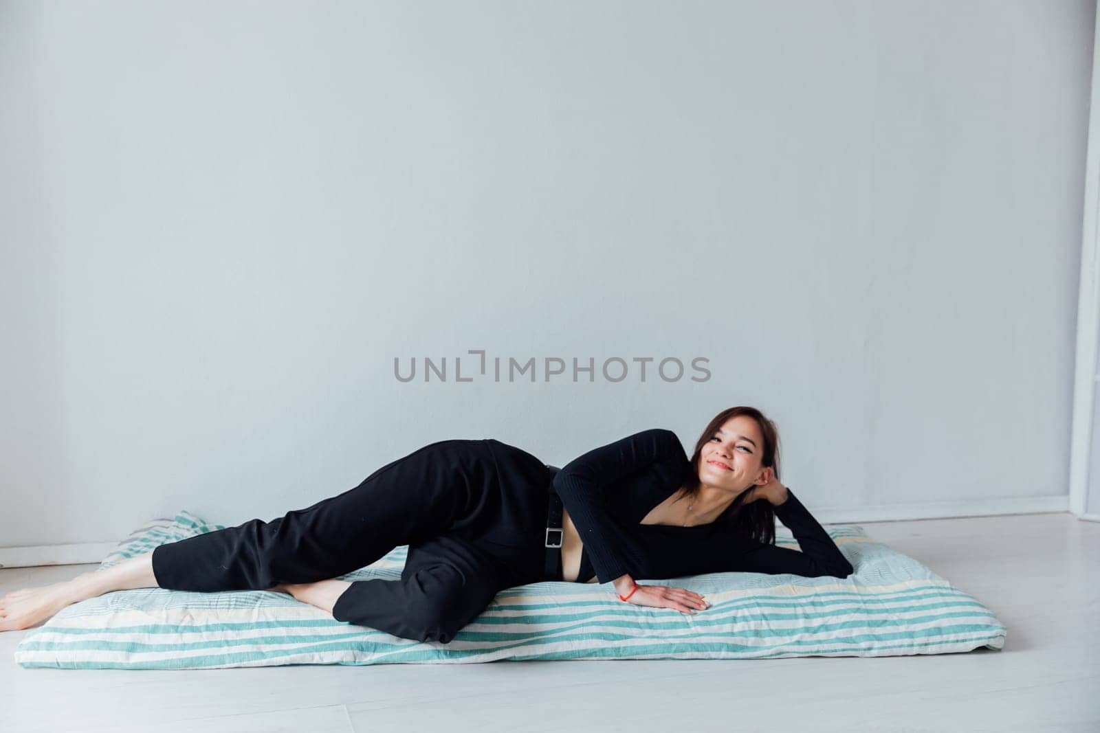 woman lying on sleeping mattress on the floor