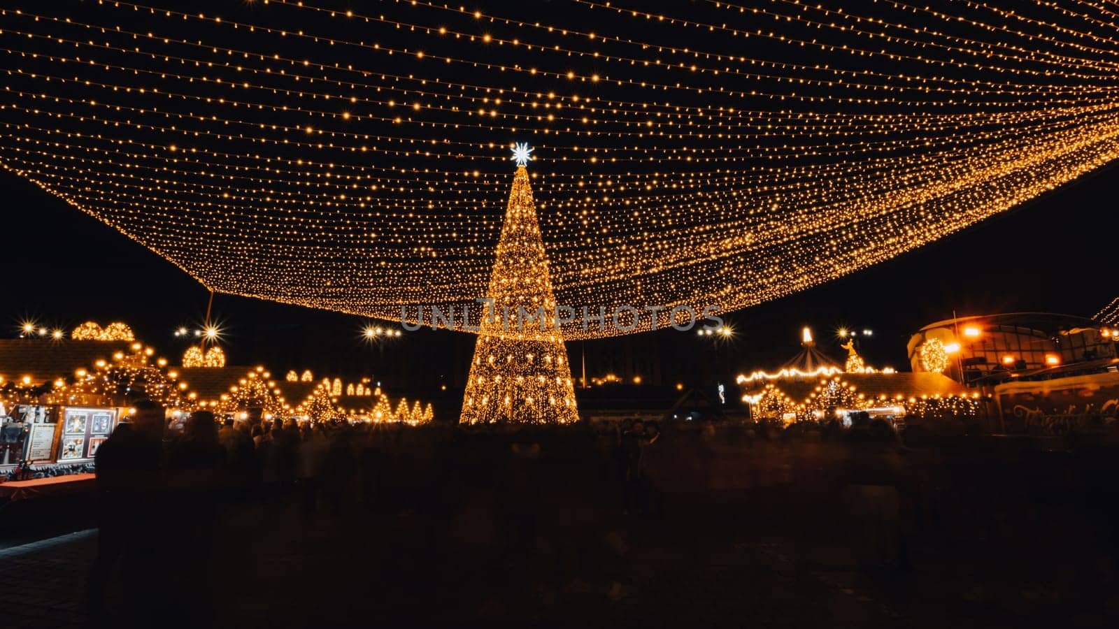 People in front of Christmas tree at Bucharest Christmas Market