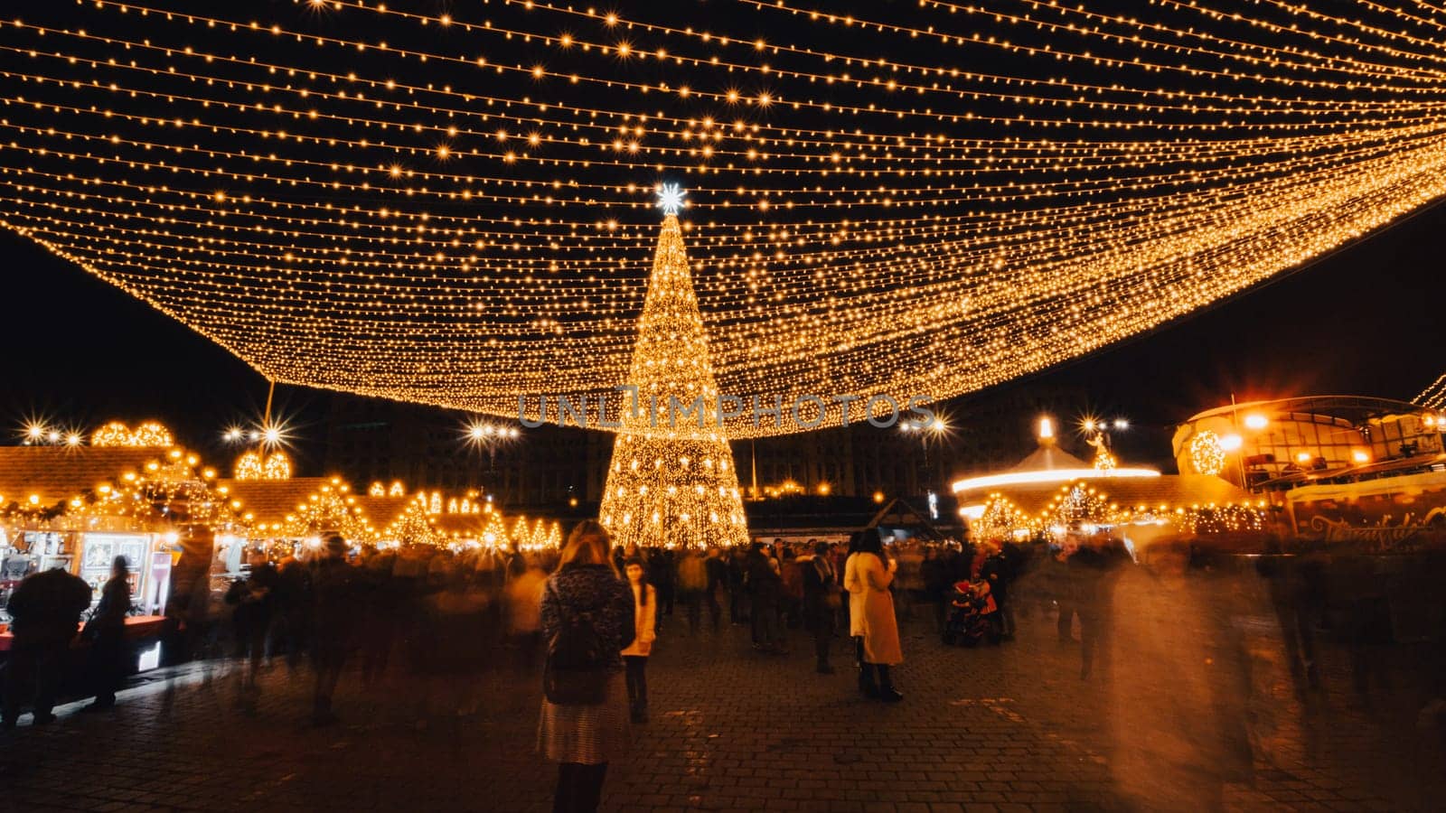 People in front of Christmas tree at Bucharest Christmas Market