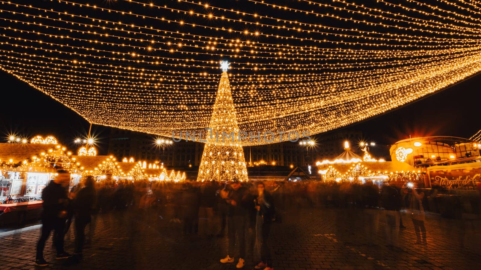 People in front of Christmas tree  by vladispas