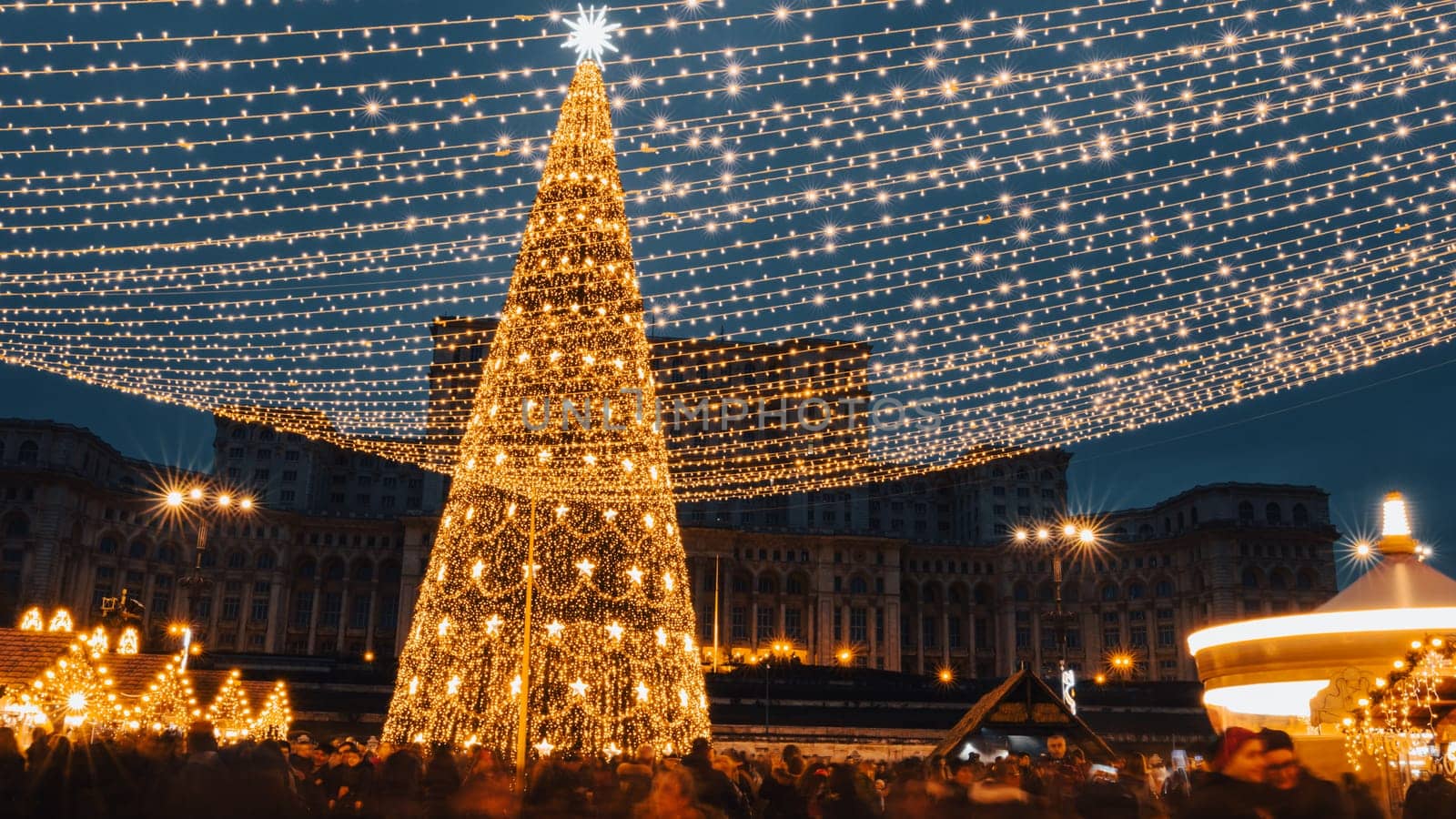 People in front of Christmas tree at Bucharest Christmas Market