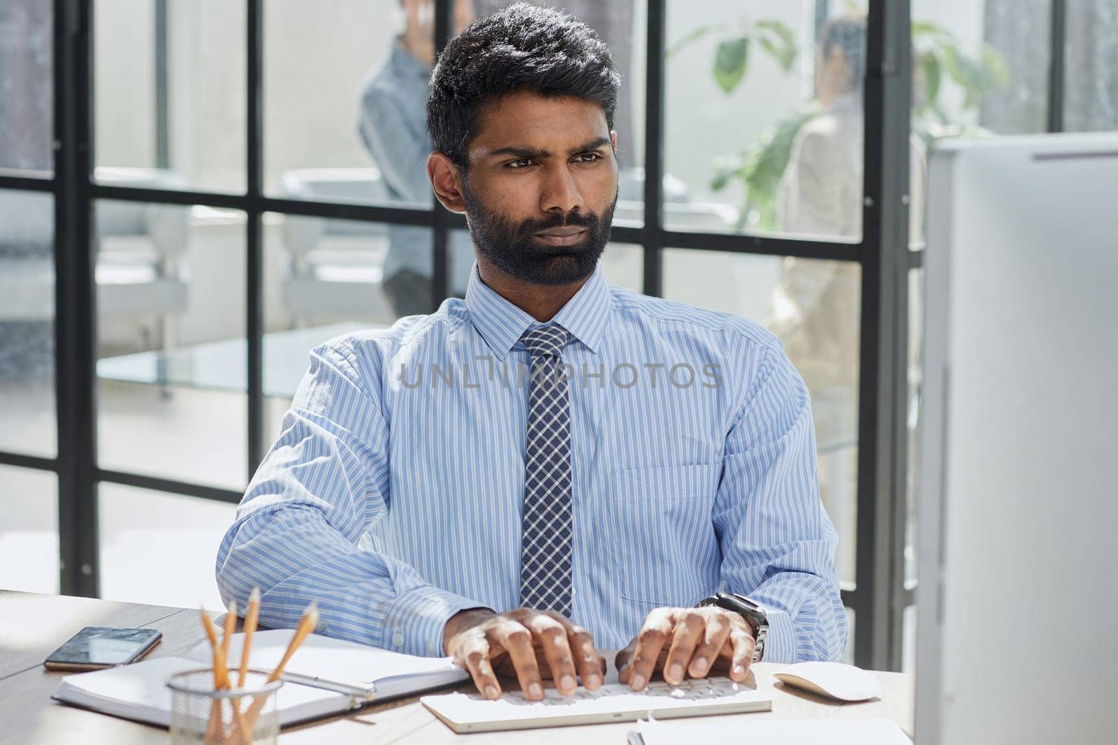 Stylish designer at work sitting. Focused on his job