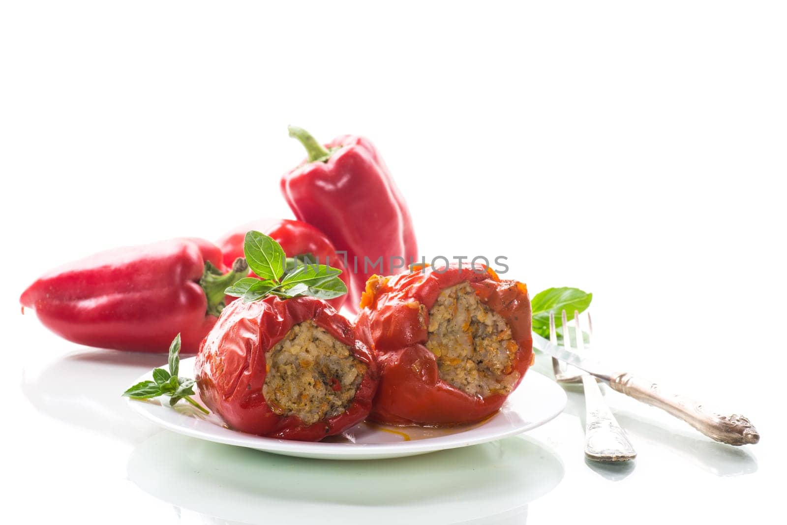 stewed in gravy stuffed peppers in a plate isolated on white background