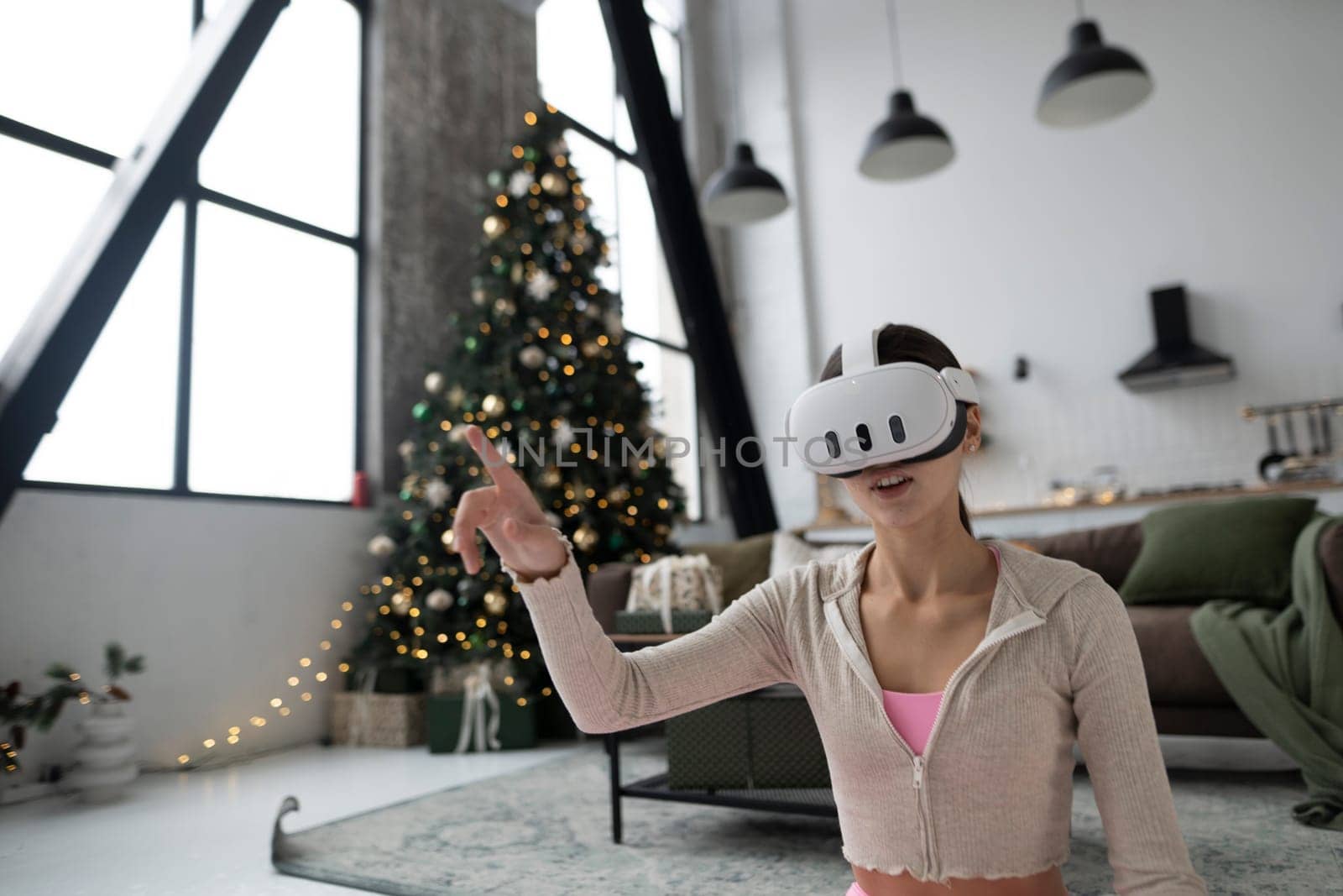 During the festive season, a trendy young woman is seen in a virtual reality headset. High quality photo