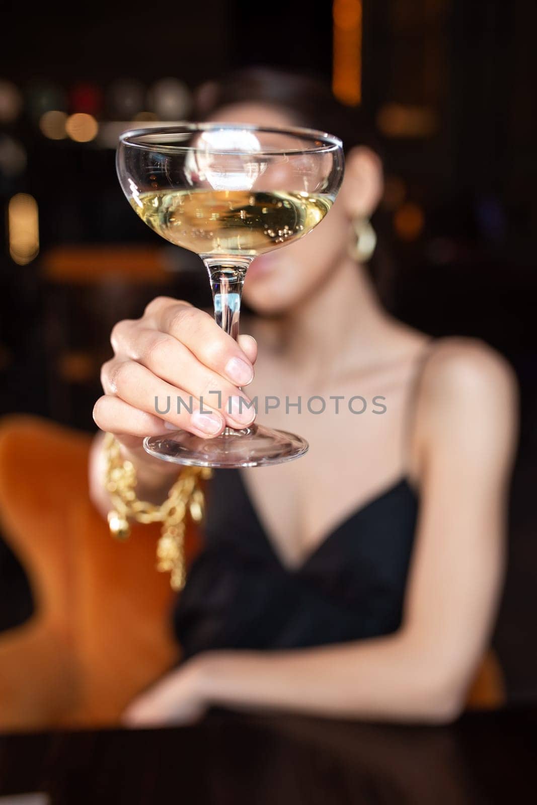 the girl covered her face with a glass of wine.