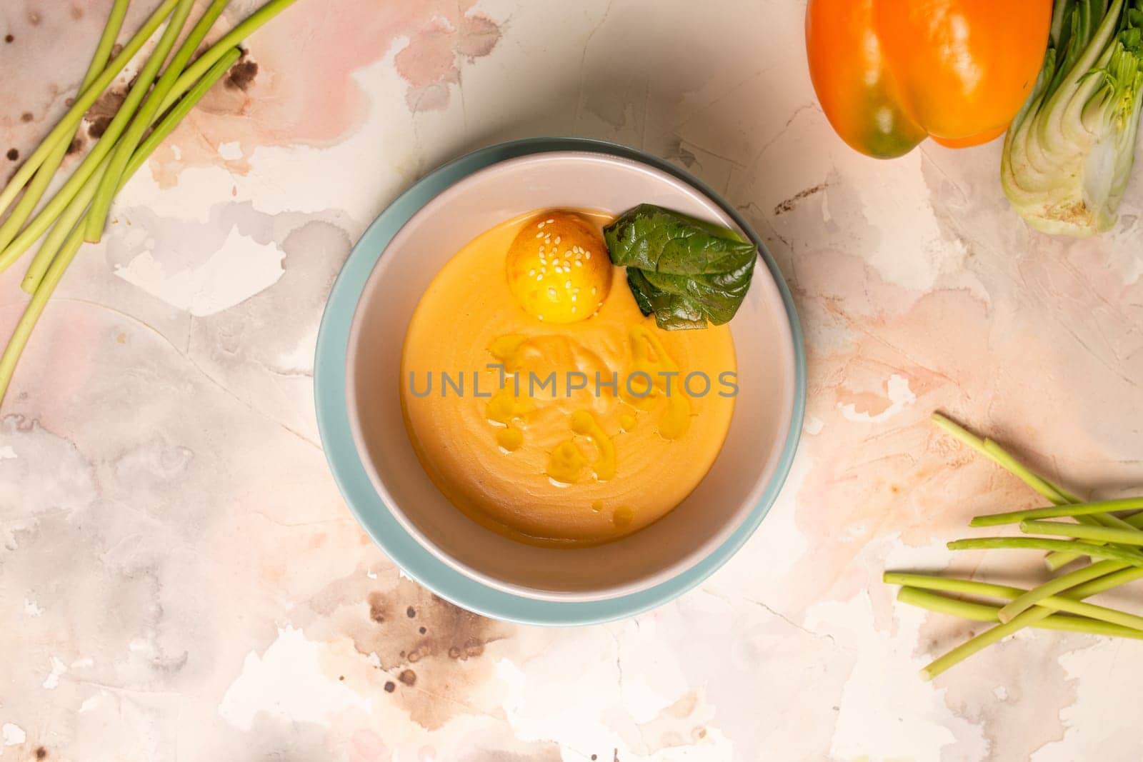 top view pumpkin cream soup with a slice of lemon in a plate on the table.