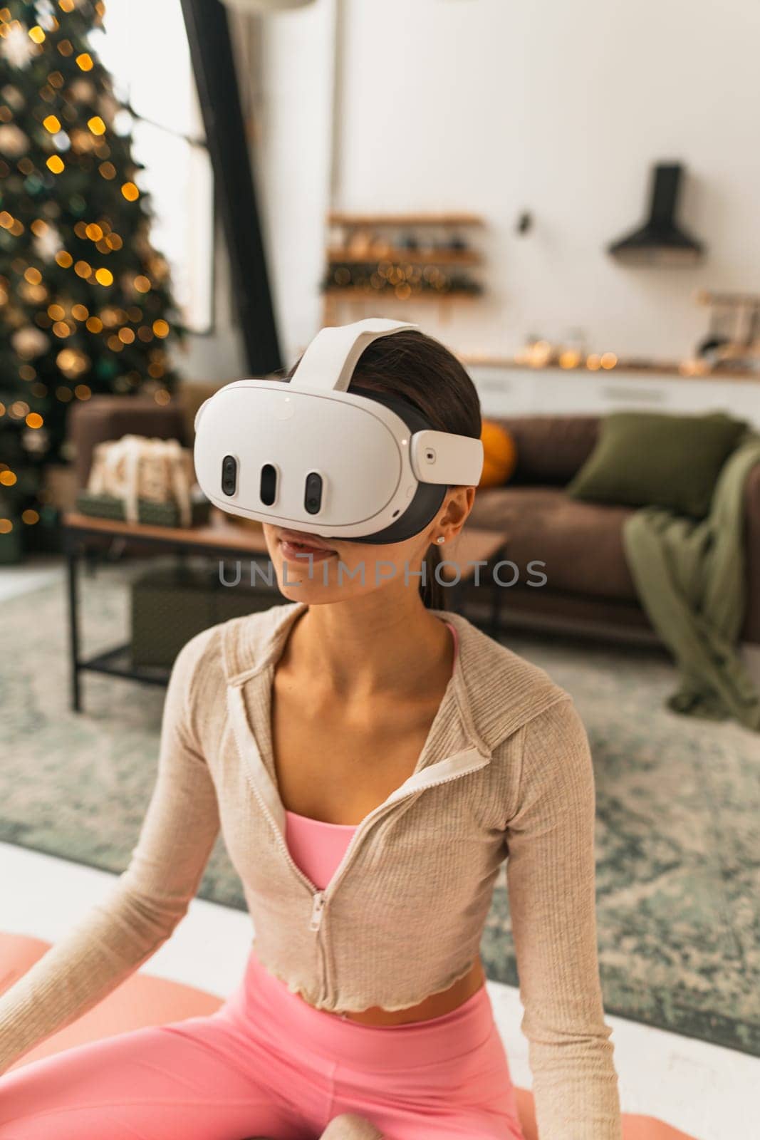 Enjoying the festive spirit, a trendy young lady wears a virtual reality headset. High quality photo