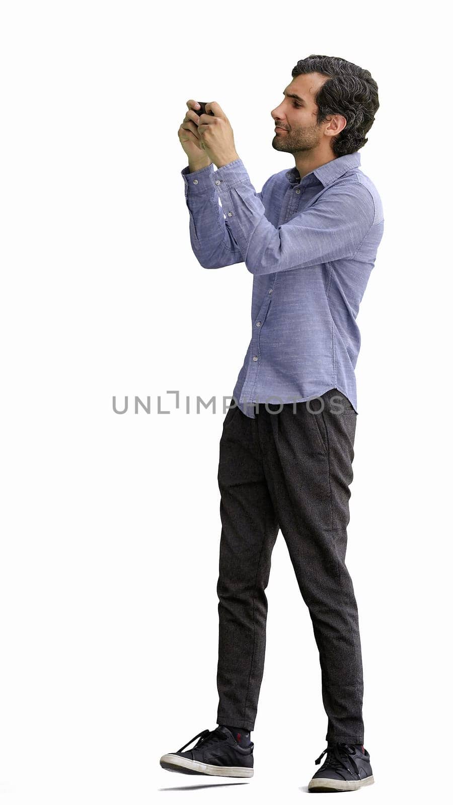 young man in full growth. isolated on white background taking selfie.