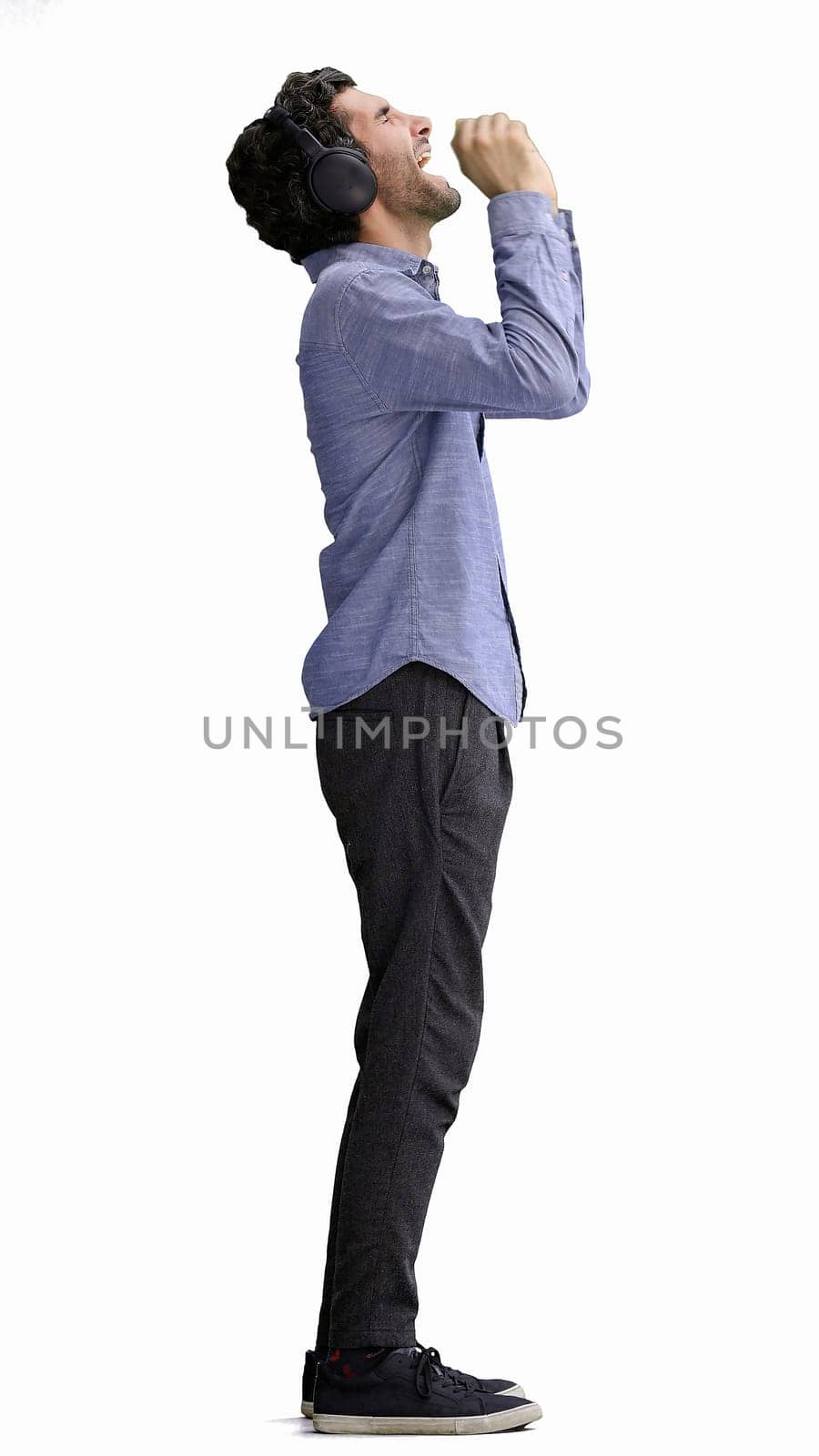 man in full growth. isolated on white background wearing headphones dancing by Prosto