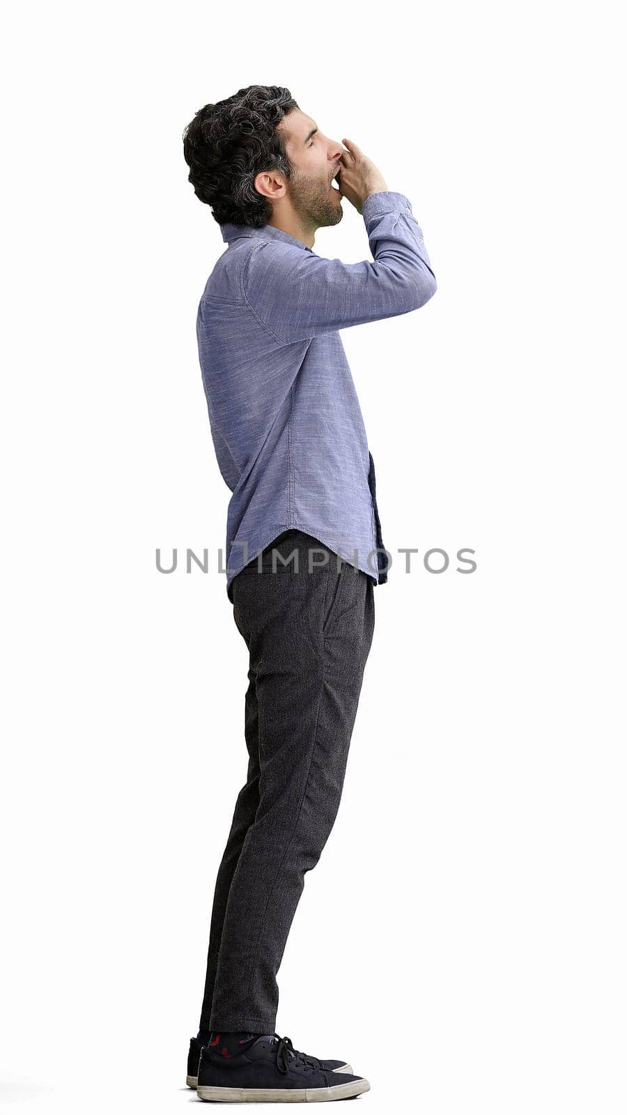 man in full growth. isolated on white background sleepy stretches.