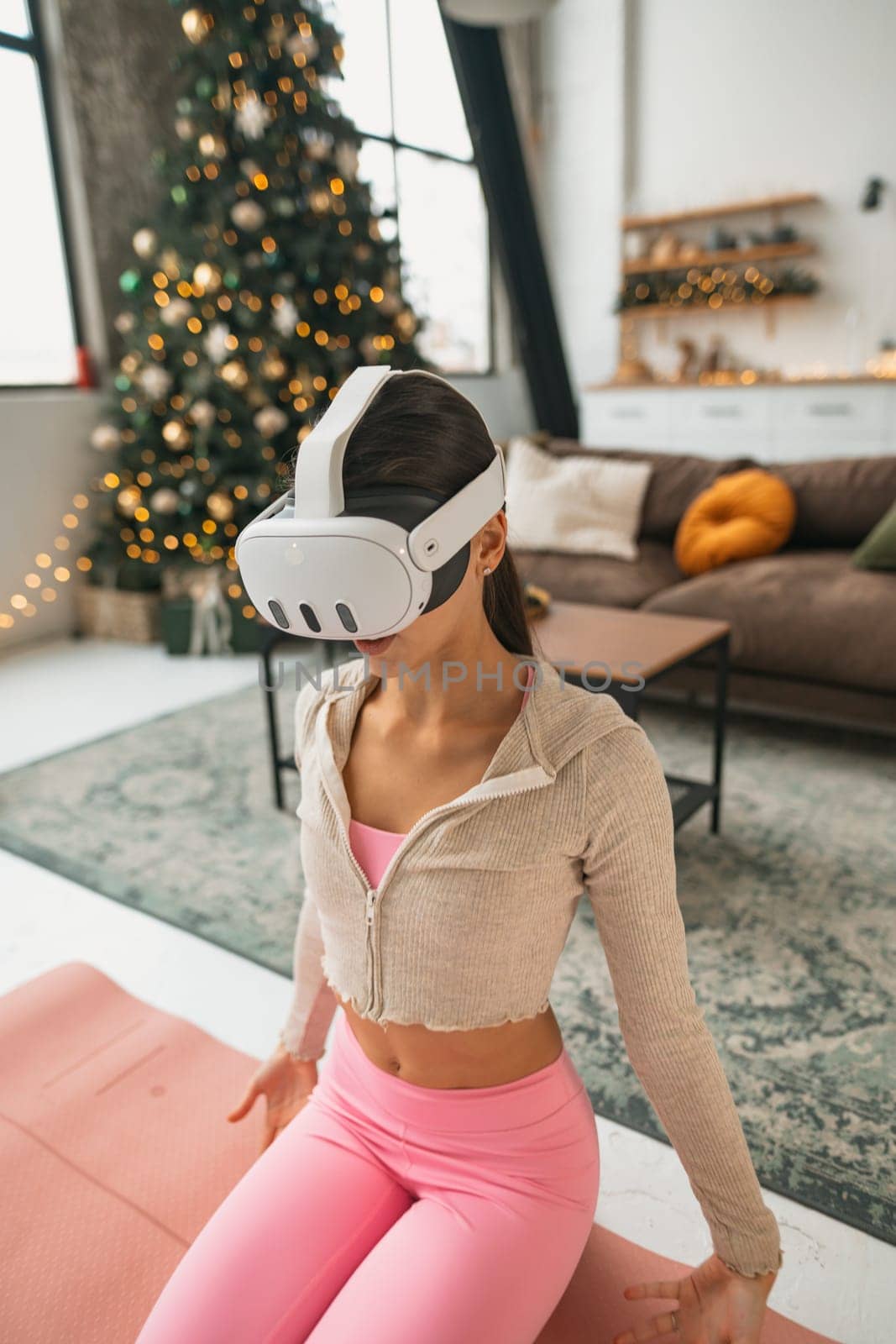 During the New Year festivities, a yoga instructor hosts online training sessions using a virtual reality headset. by teksomolika