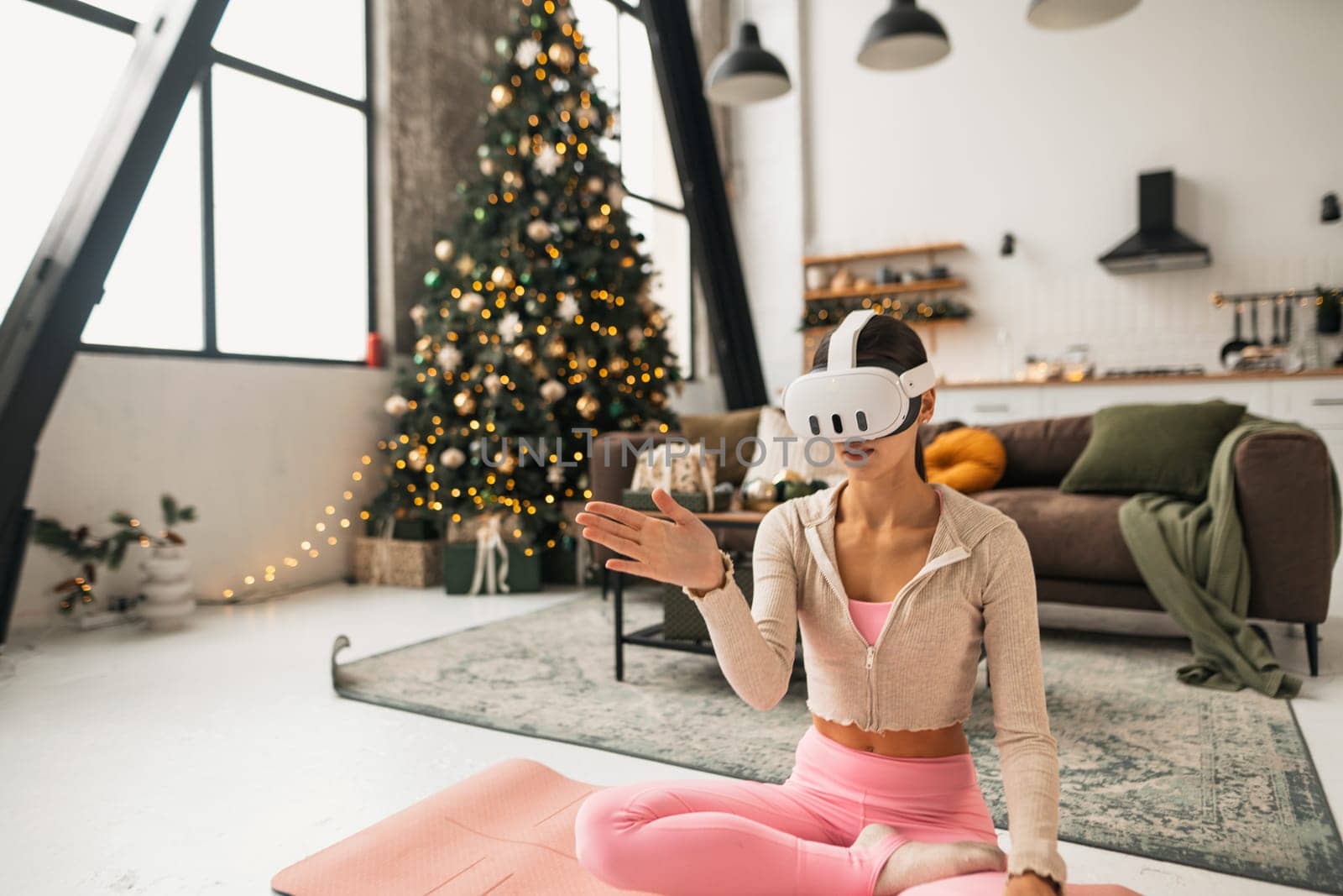 A stylish young woman in a virtual reality headset during the holiday season. High quality photo
