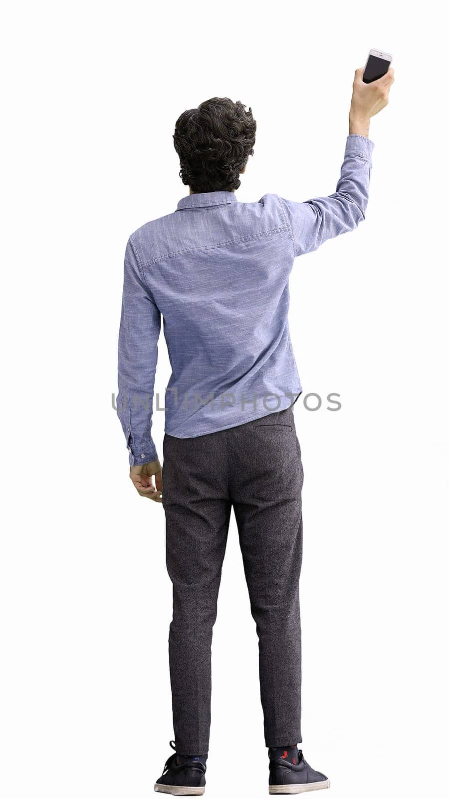 young man in full growth. isolated on white background rejoices.