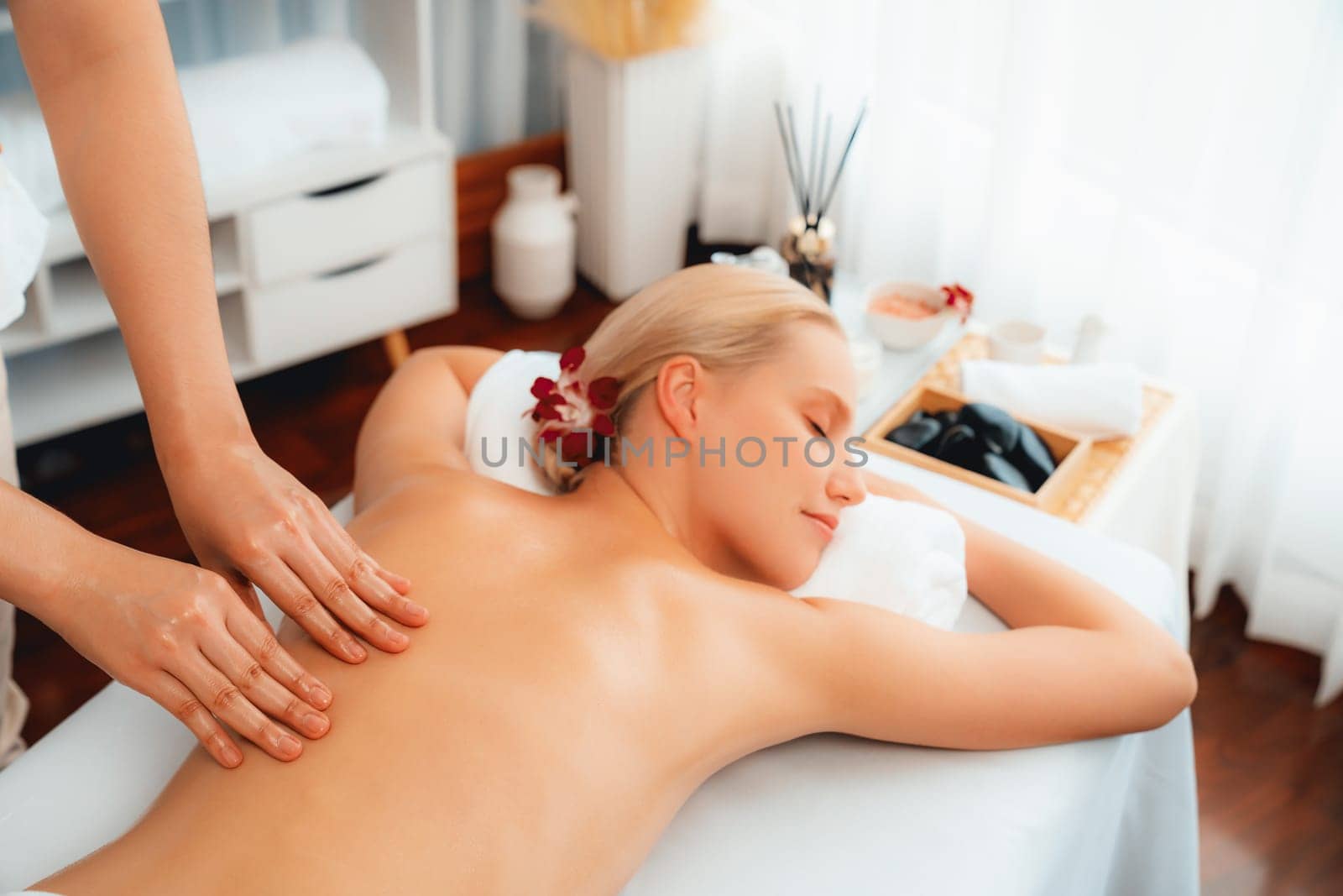 Caucasian woman customer enjoying relaxing anti-stress massage. Quiescent by biancoblue