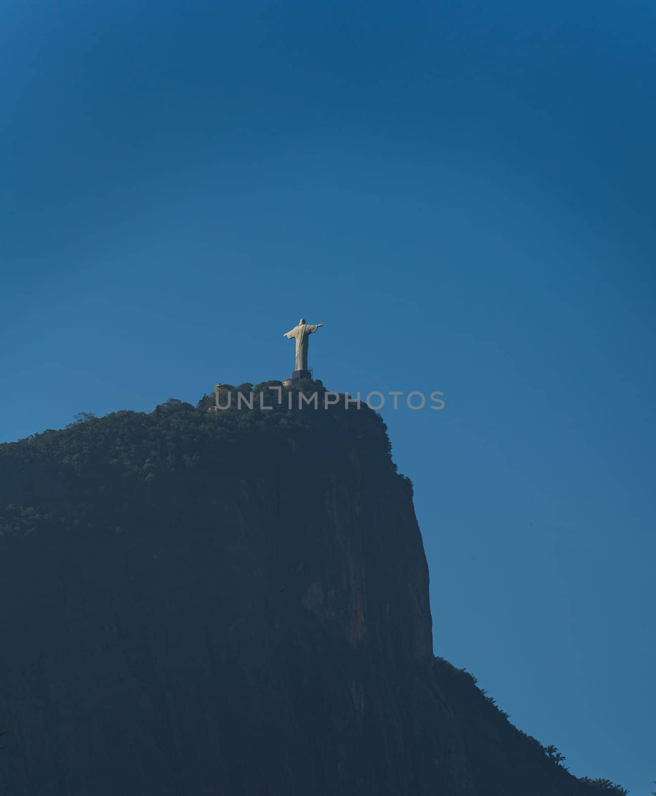 Stunning Back View of Christ Statue in Rio with Clear Blue Sky Background by FerradalFCG