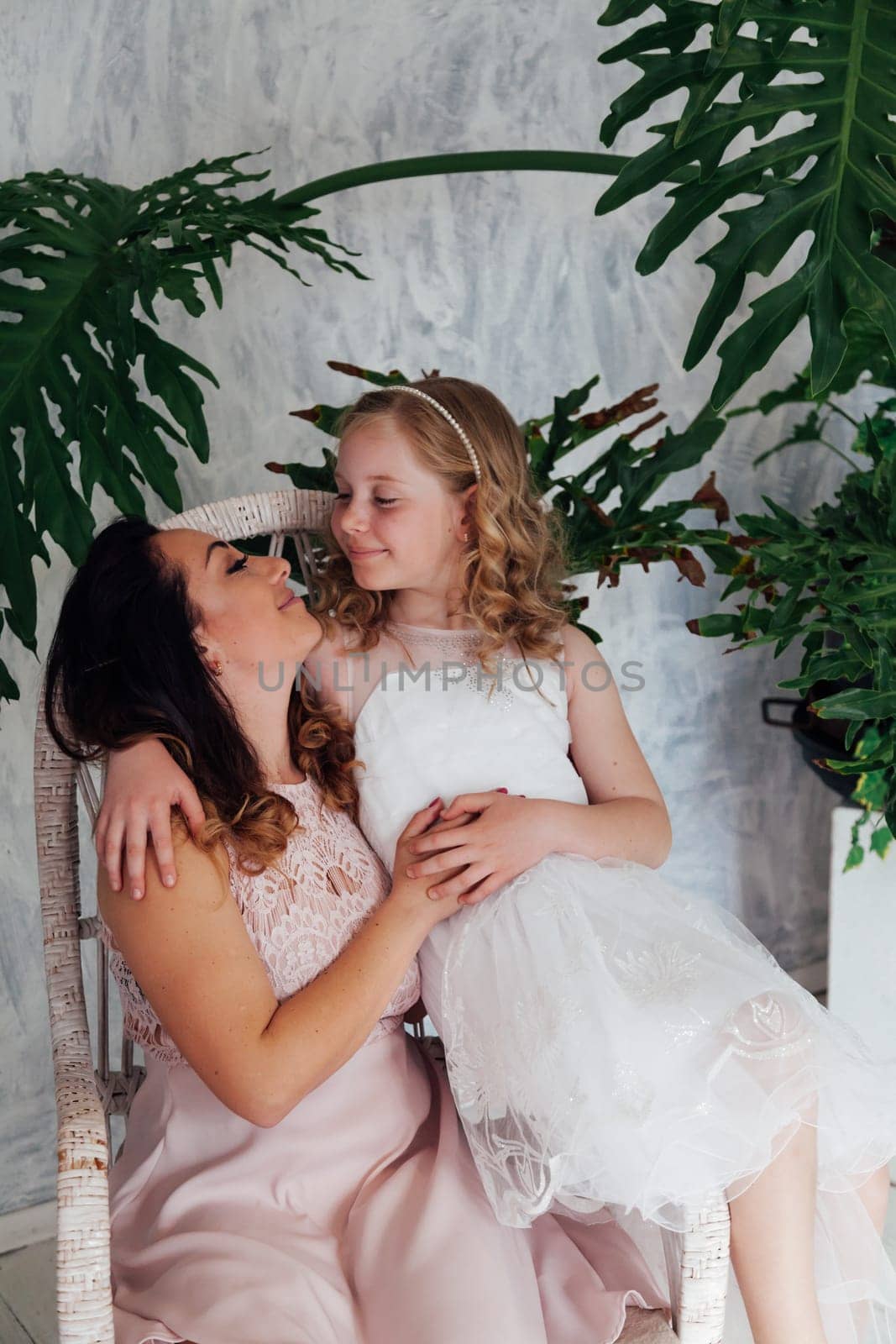 Family mom with daughter in light dresses