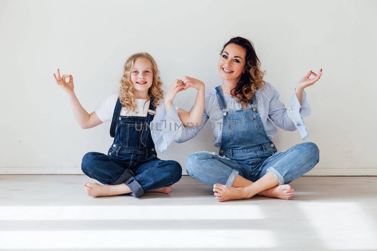 Family happy mom with daughter in denim clothes by Simakov