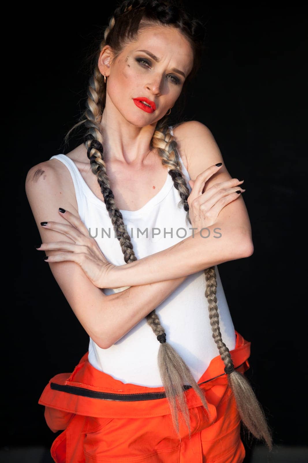 Portrait of a beautiful fashionable woman mechanic with two braids