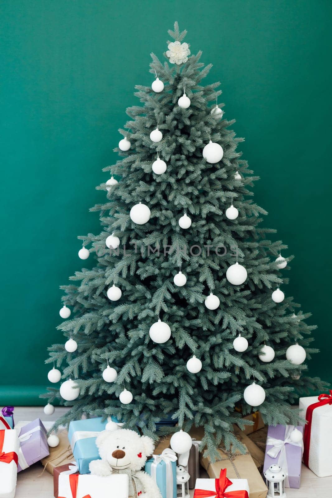 New Year's Christmas tree decor with gifts and interior garlands
