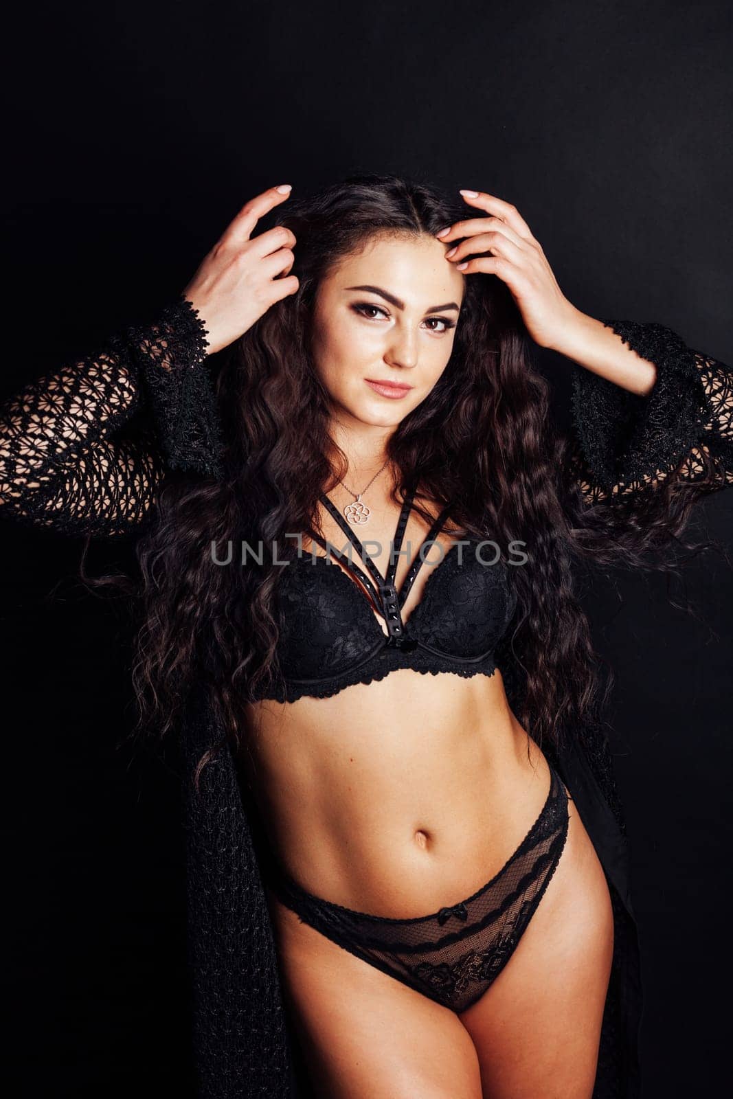 Portrait of a beautiful fashionable brunette woman in black lingerie by Simakov