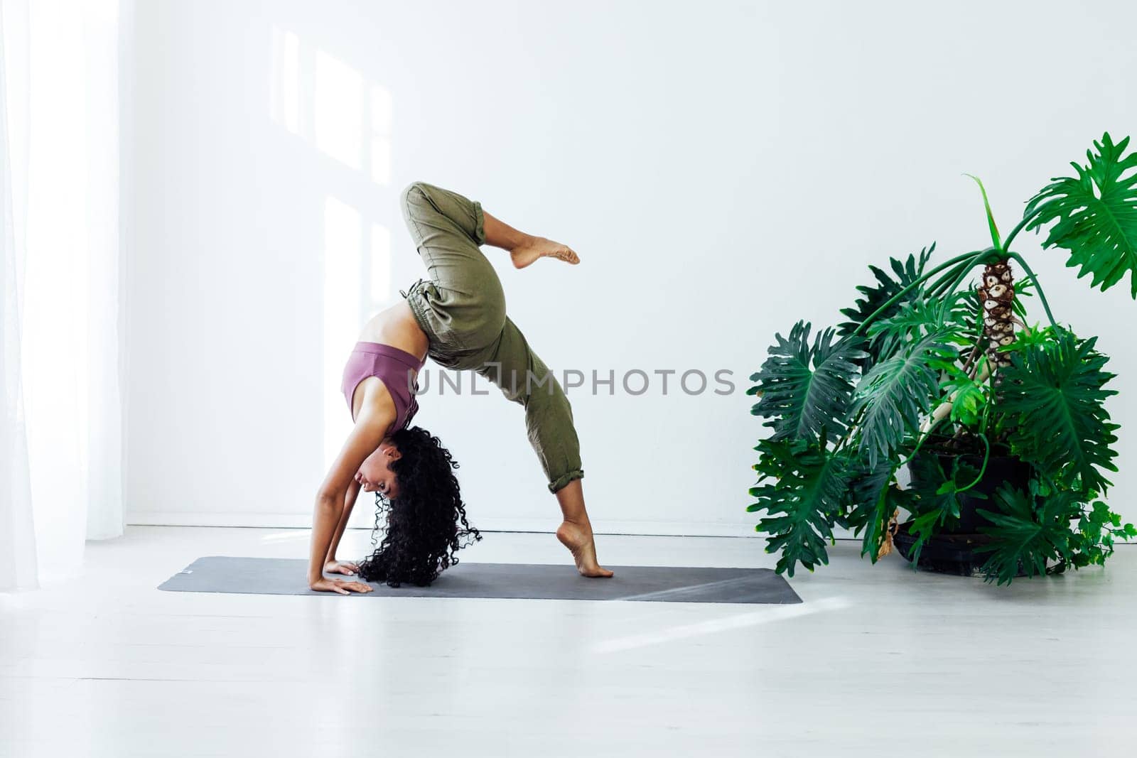 Beautiful female brunette yoga fitness sports asana body flexibility by Simakov