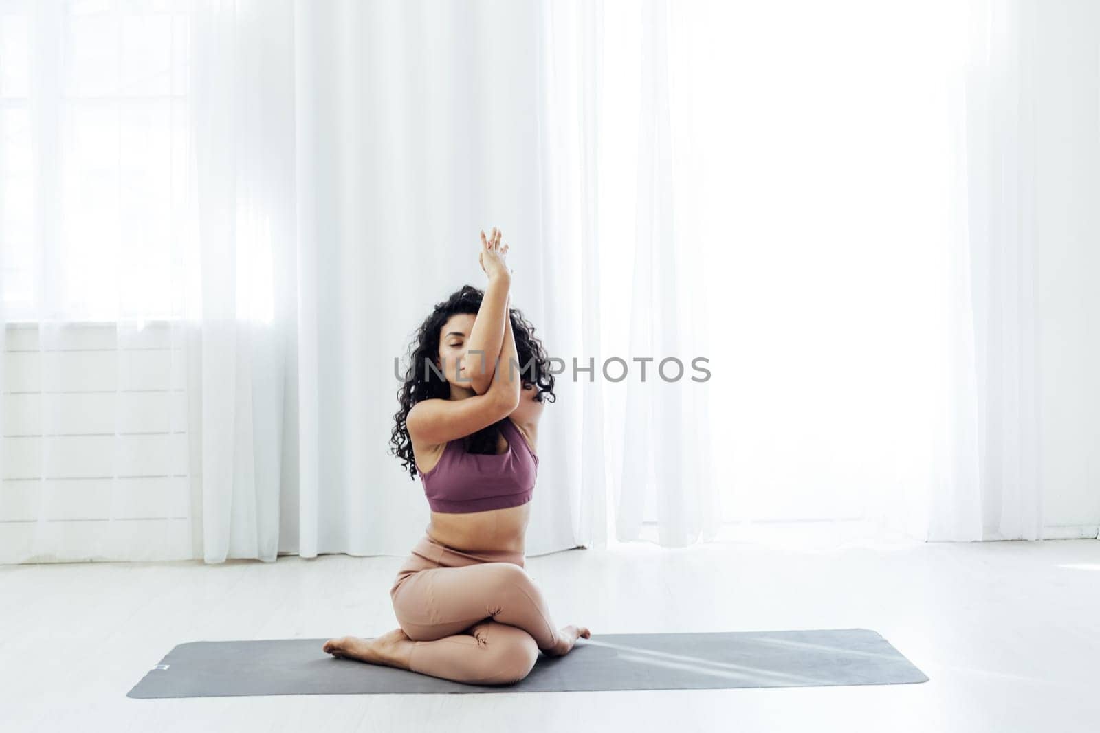 Beautiful female brunette yoga fitness sports asana body flexibility by Simakov